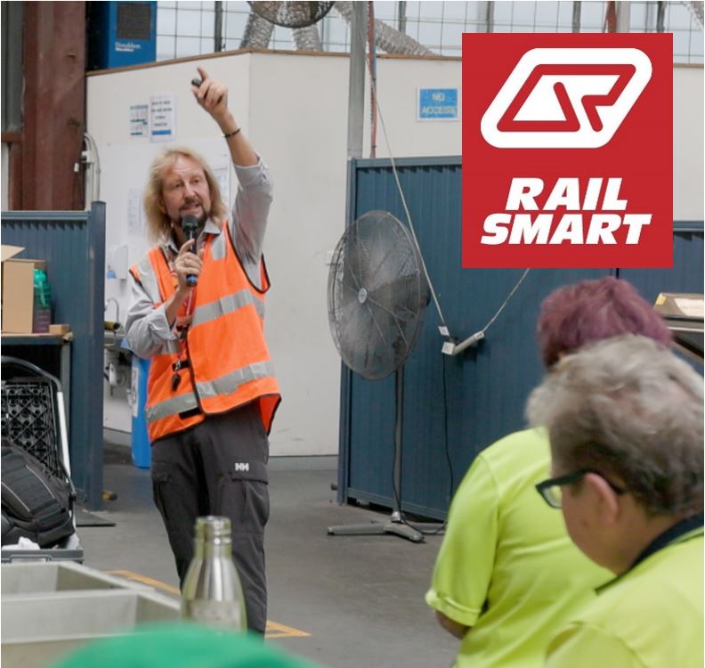 A Queensland Rail educator presenting to a group of school students