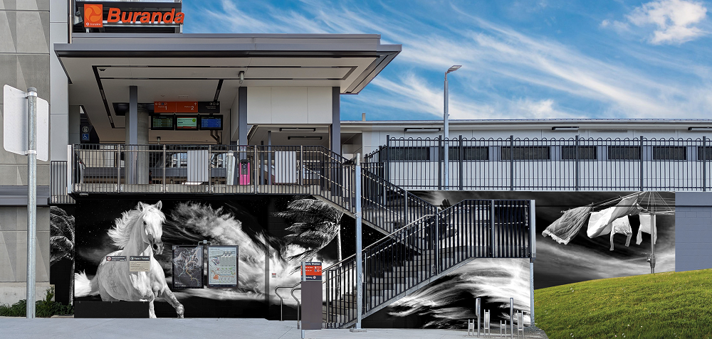 Concept of a mural at the Buranda station southern entrance including a black and white image of a horse, palm tree and a hills 