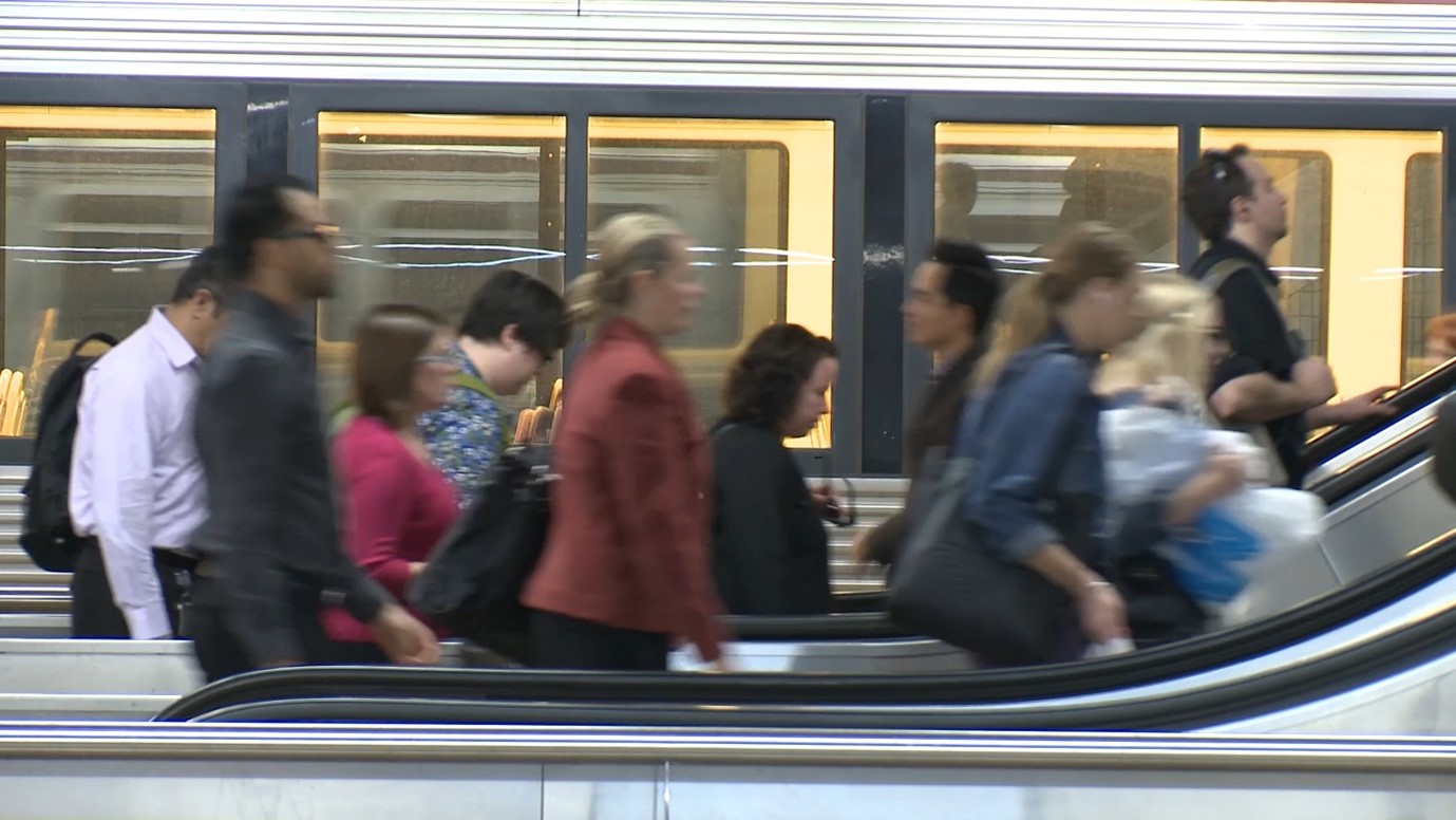 Customers on escalators travelling from the platform  to the concourse at Central station