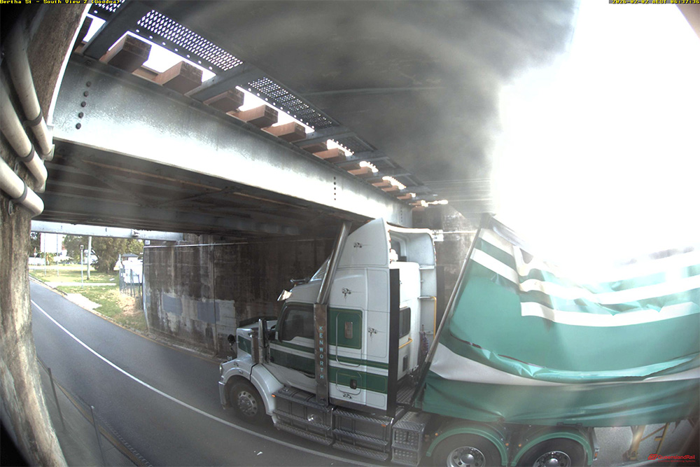 Truck stuck under a rail bridge