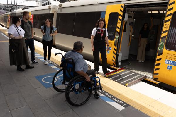 station staff member assisting with a boarding ramp