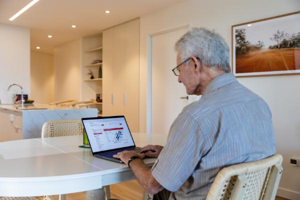 Older male using computer to plan his journey