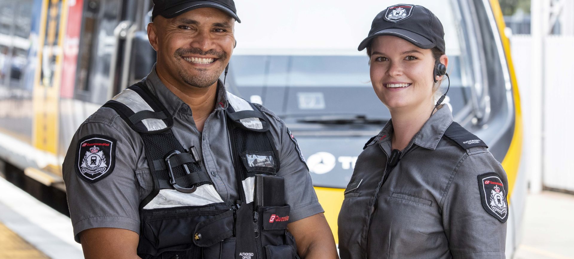 Two Authorised Officers standing in front of a train