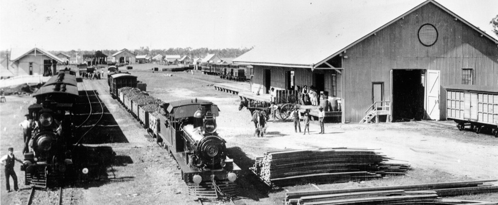 A black and white photograph of Roma railway station yards taken between the years 1900 and 1905,full image description is available below. 