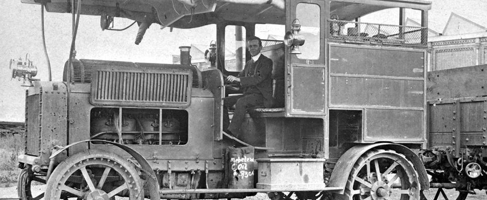 A black and white photo of the innovative Renard Road Train taken at North Ipswich Workshops in 1910, full image description is available below.