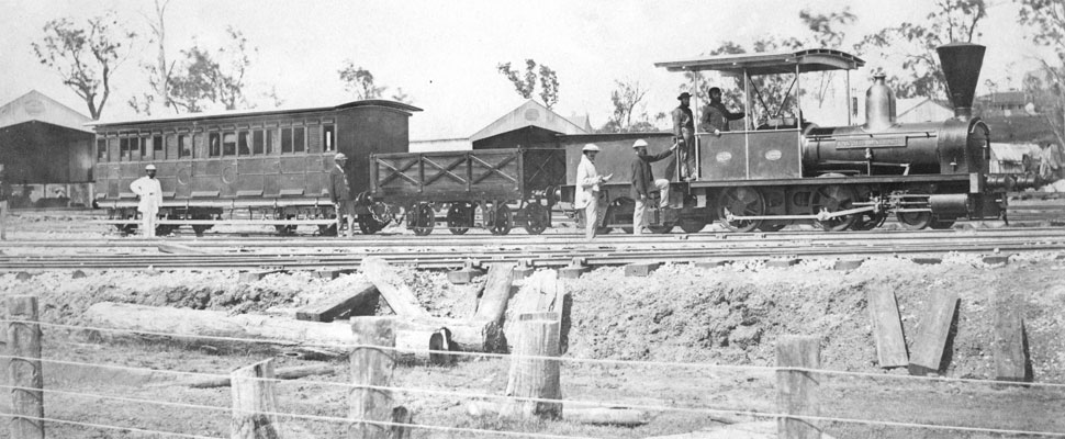 black and white photograph shows the first steam locomotive in Queensland,full image description is available below.